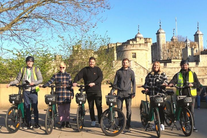 a group of people standing around a motorcycle