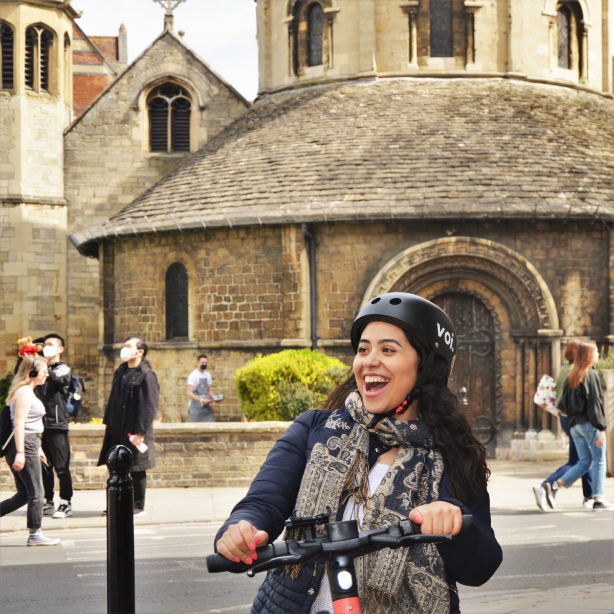 a person walking down a street in front of a building