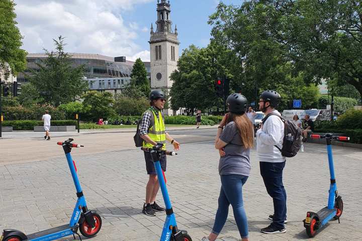 a group of people flying kites in the sky