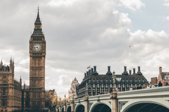 a bridge over water with a city in the background
