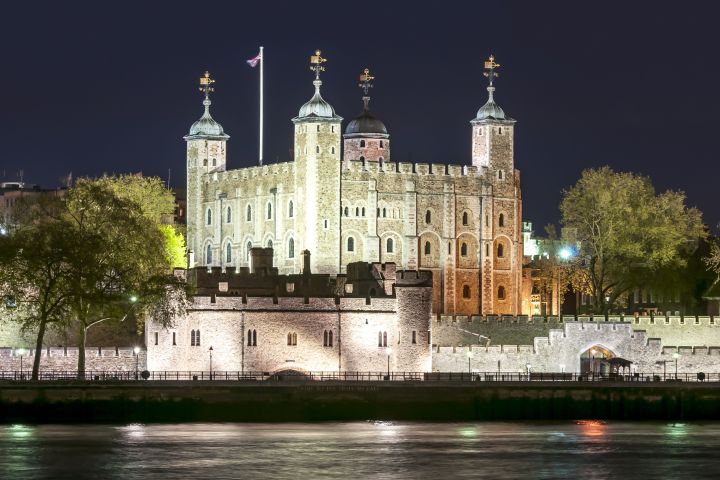 a castle with water in front of Tower of London