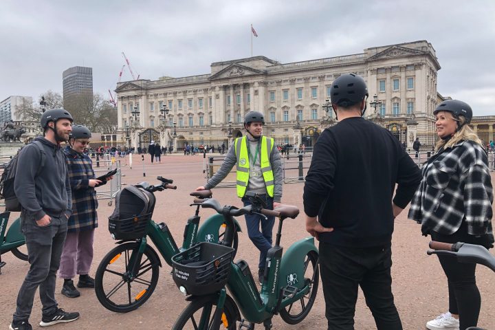 a group of people standing around a motorcycle in front of a building