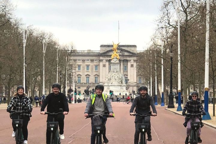 a group of people riding bikes down a street