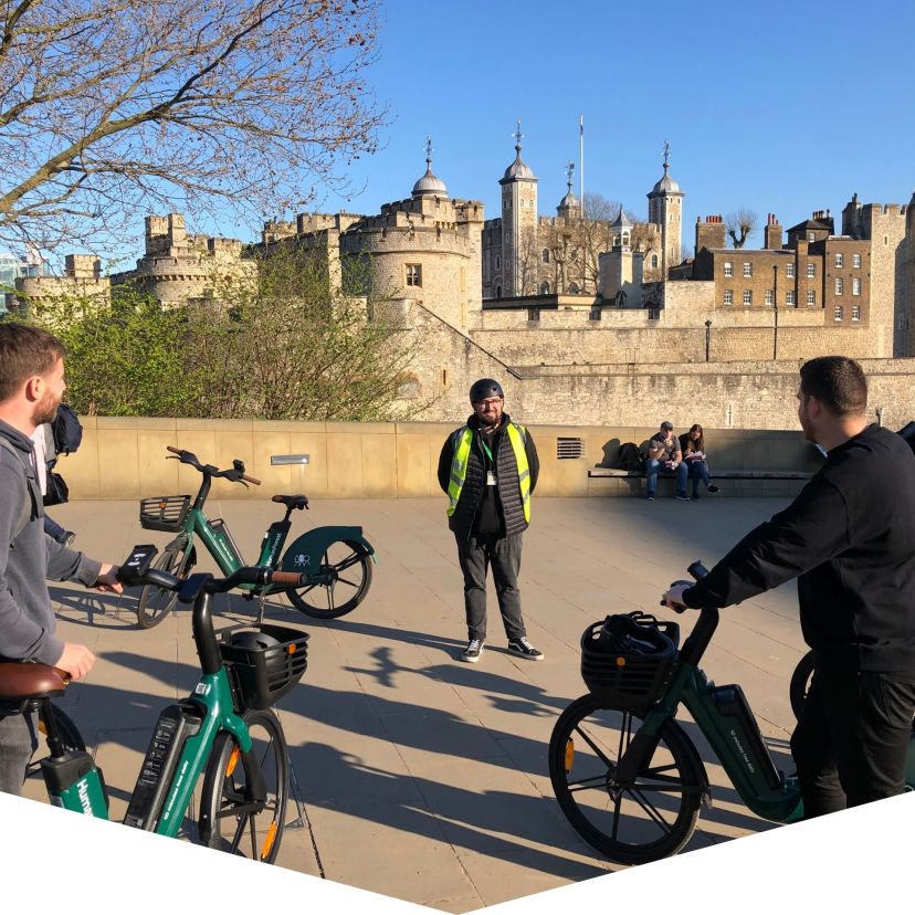 a group of people riding on the back of a bicycle